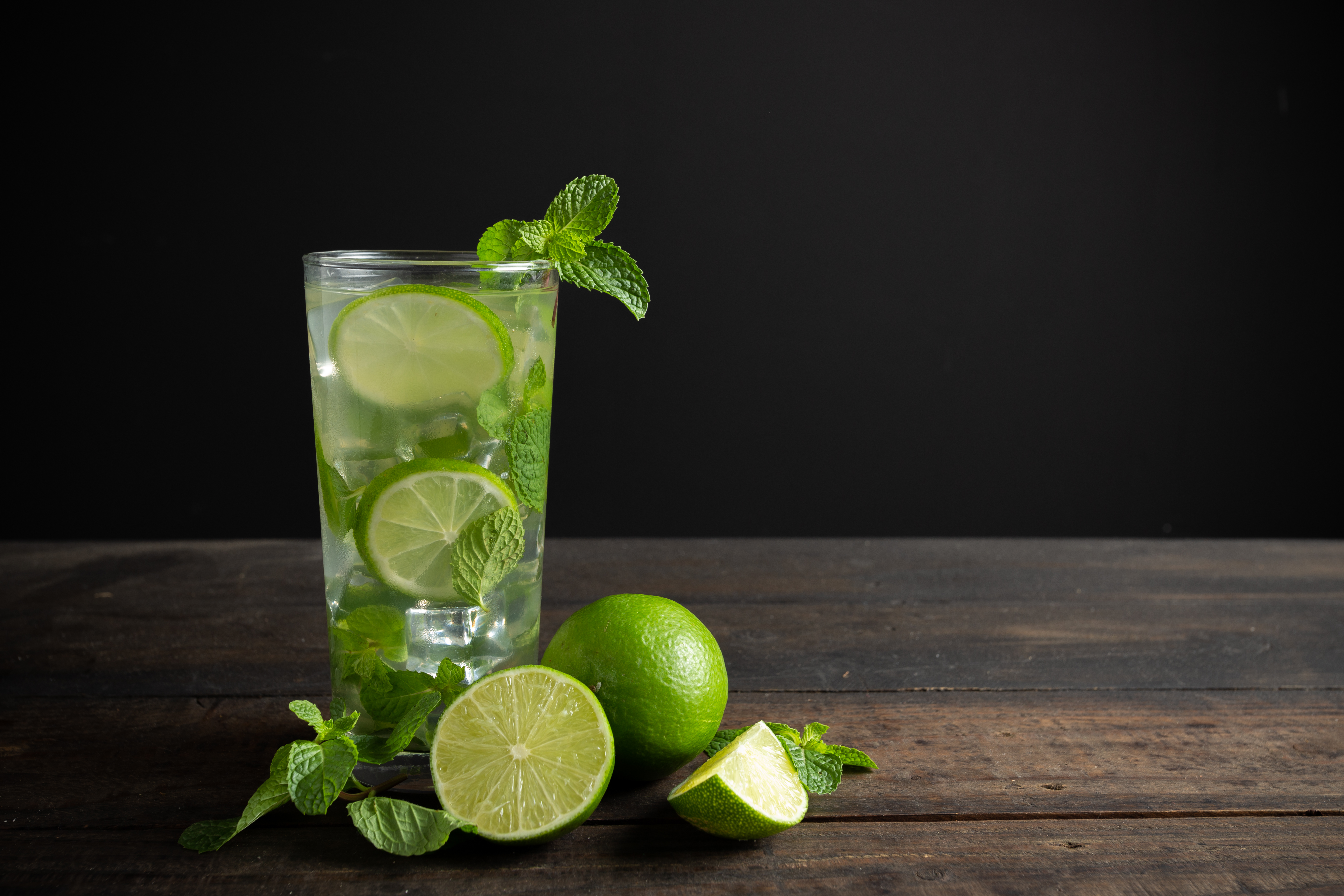mojito drink with lime lemon mint wood table